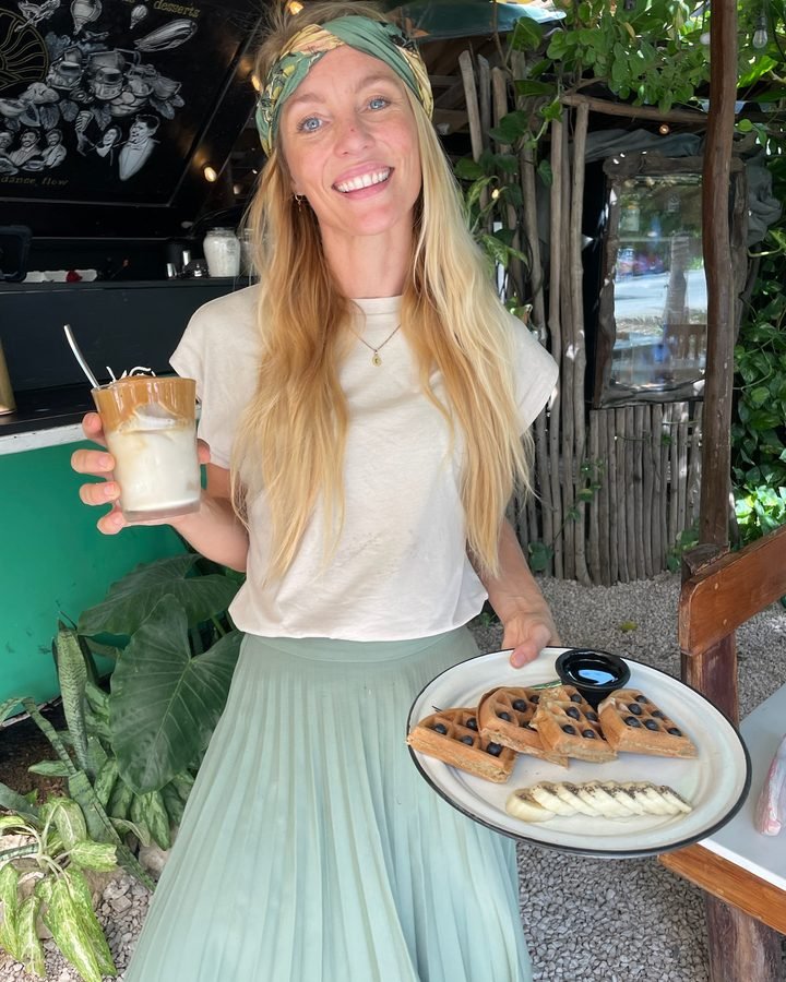 Fem, Liefs co-founder, holding a plate of waffles in Tulum