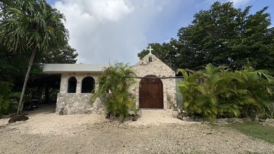 Chapel with cross and wooden door at Rancho Verde Tulum