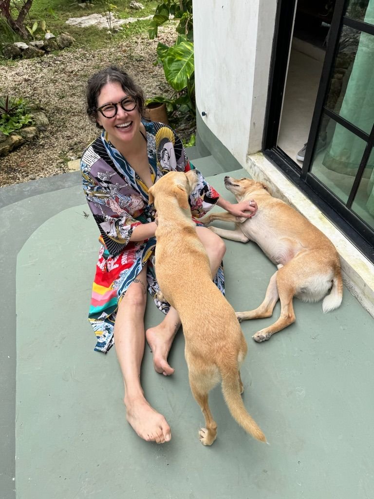 Guest with two dogs on the terrace at Rancho Verde Tulum