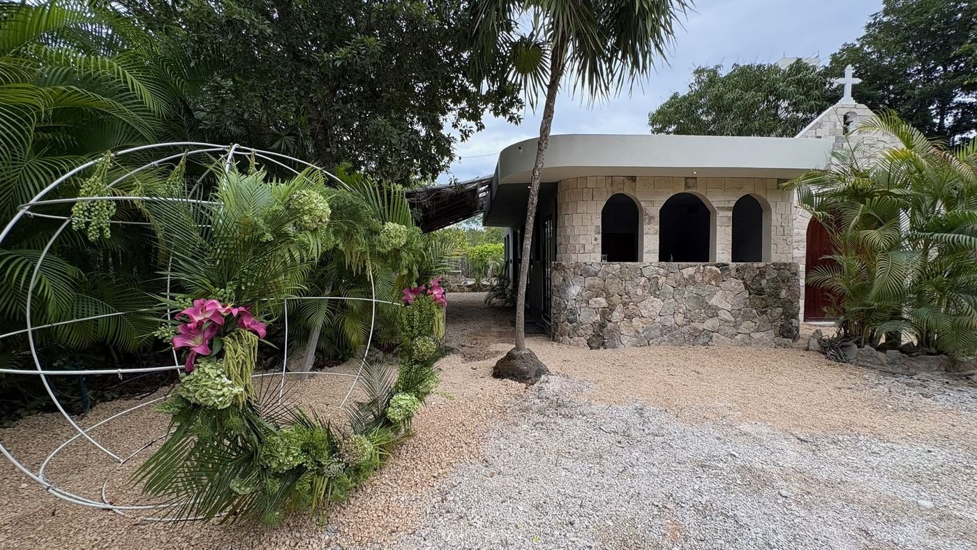 Chapel with a white hoop arch of flowers at Rancho Verde Tulum